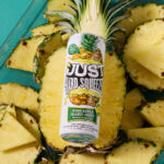 can of just hard squeezed pineapple laying on a bed of fresh pineapple