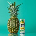 a can of just hard squeezed pineapple next to a pineapple