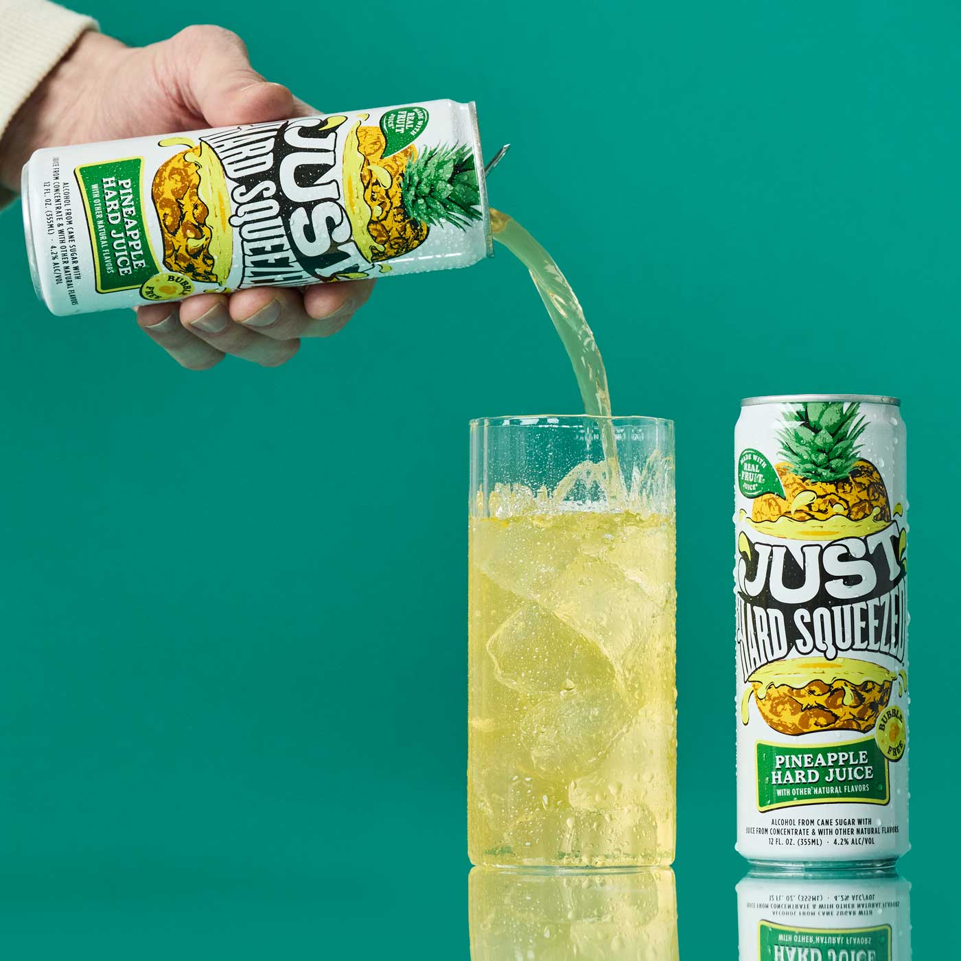 a can of just hard squeezed pineapple next to a glass being poured into