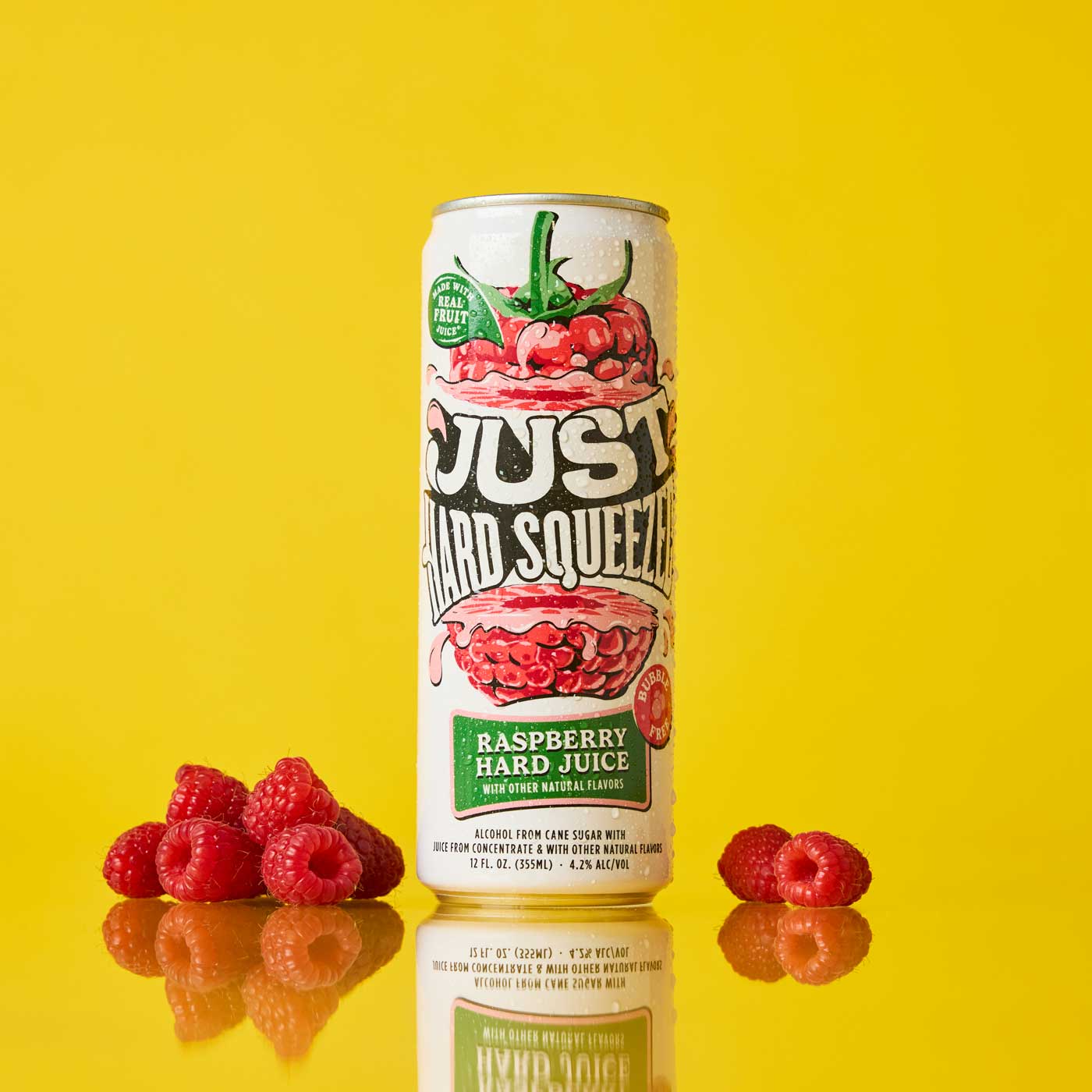 a can of just hard squeezed raspberry next to fresh raspberries