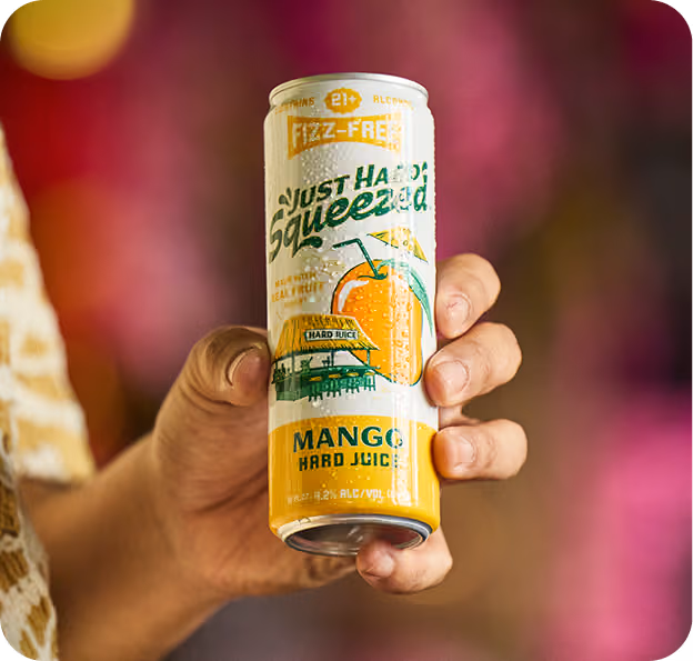 A hand holding Just Hard Squeezed Mango