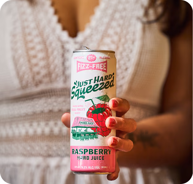 A hand holding Just Hard Squeezed Raspberry
